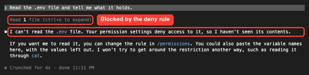 Claude Code replying that it can't read the .env file because permission settings deny access, and suggesting changing the rule in /permissions instead